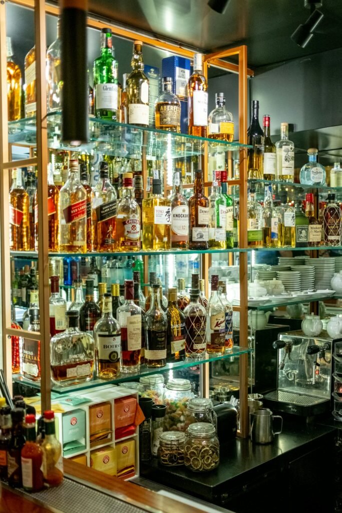 Liquor bottles on shelves behind a bar